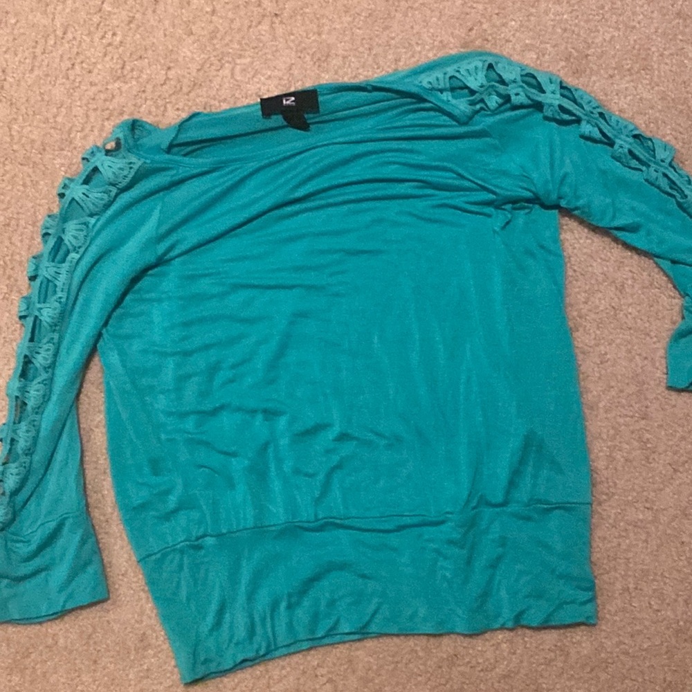 Medium long sleeved top with distressed sleeves.